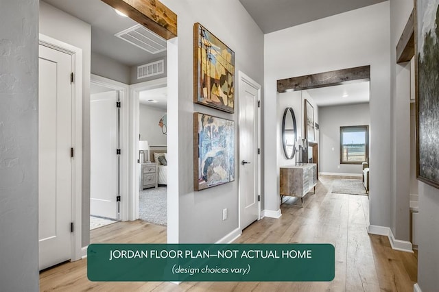 hallway featuring beam ceiling and light hardwood / wood-style flooring