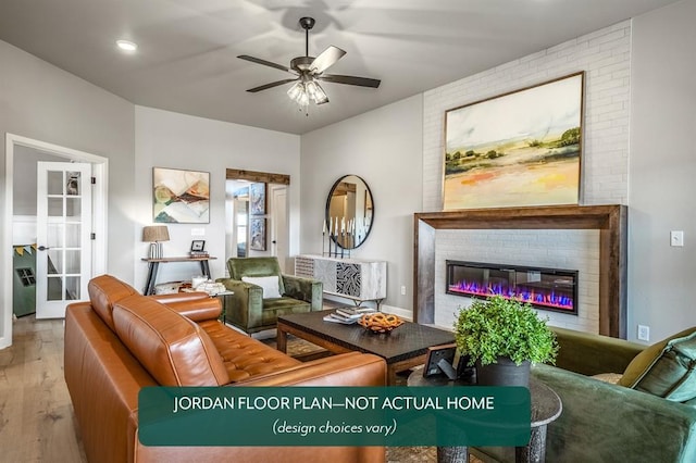 living room with ceiling fan, light hardwood / wood-style floors, and a brick fireplace