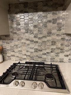 interior details with light countertops and stainless steel gas stovetop