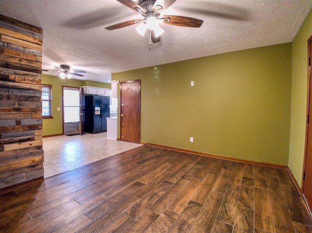 unfurnished living room with ceiling fan, wood-type flooring, and a textured ceiling