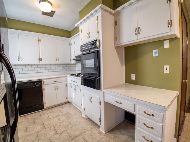 kitchen with white cabinetry, backsplash, and black appliances