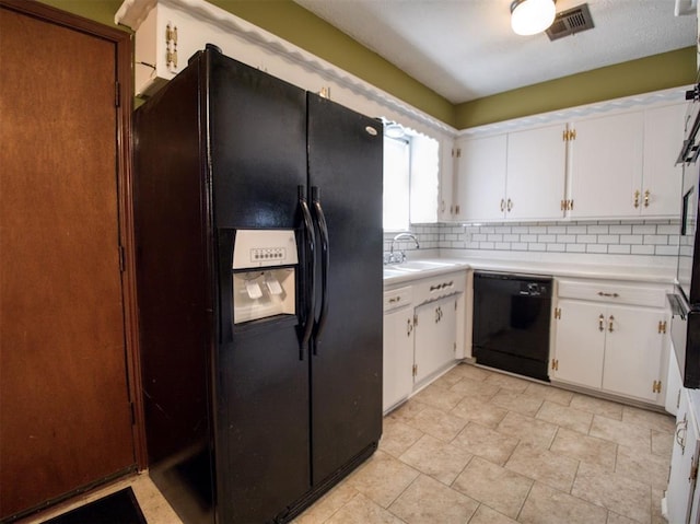 kitchen featuring white cabinetry, sink, decorative backsplash, and black appliances