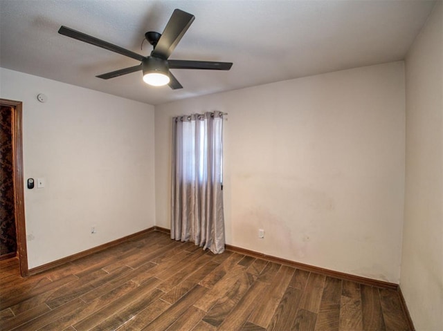 spare room featuring ceiling fan and dark hardwood / wood-style flooring