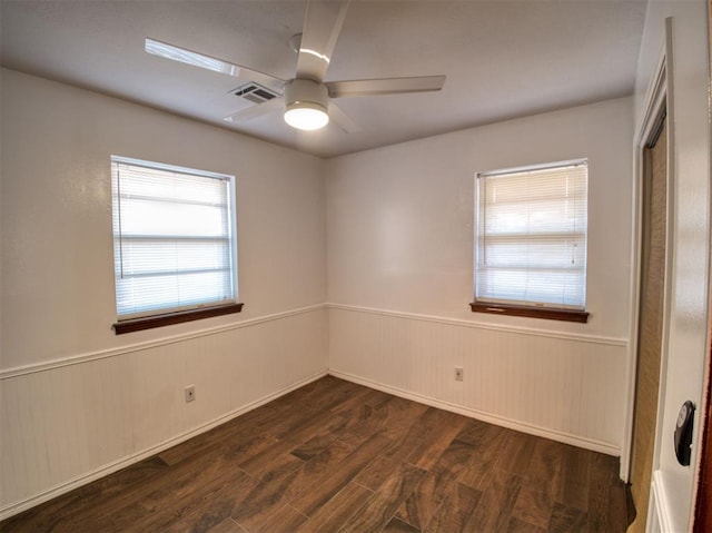 unfurnished room featuring dark hardwood / wood-style floors and ceiling fan