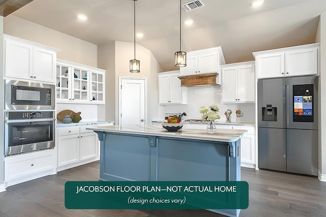 kitchen with stainless steel appliances, white cabinetry, an island with sink, and decorative light fixtures