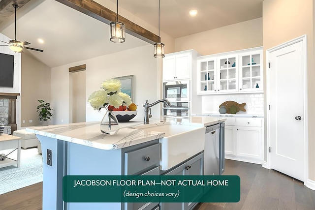 kitchen featuring pendant lighting, sink, appliances with stainless steel finishes, white cabinetry, and a kitchen island with sink