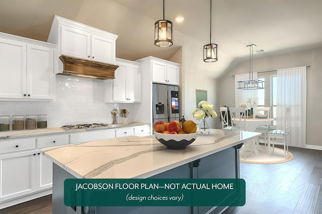 kitchen with stainless steel appliances, lofted ceiling, white cabinets, and decorative light fixtures