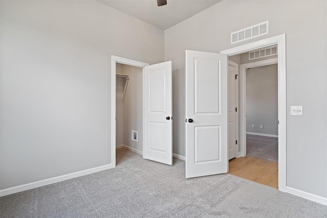 unfurnished bedroom featuring carpet, visible vents, and baseboards