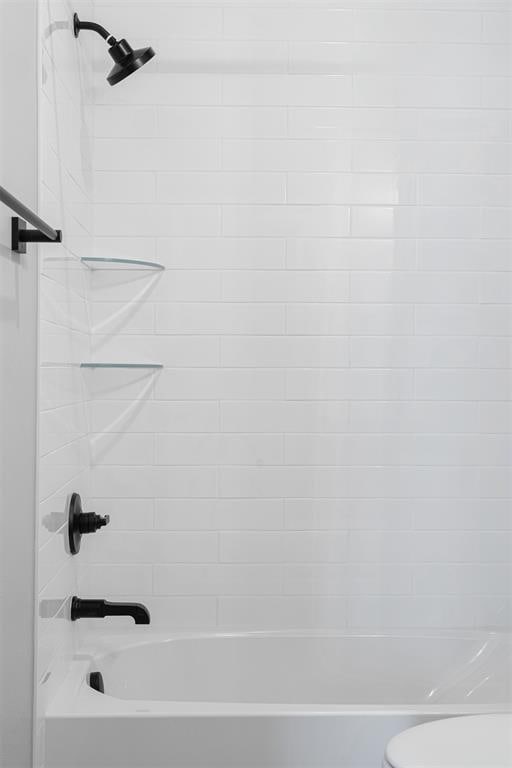 full bath featuring  shower combination and toilet