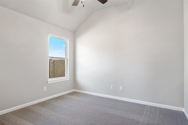 carpeted spare room featuring lofted ceiling, a ceiling fan, and baseboards