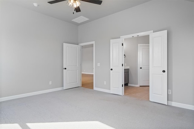 unfurnished bedroom featuring a ceiling fan, visible vents, baseboards, and carpet flooring