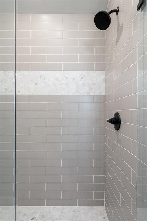 full bath featuring a tile shower