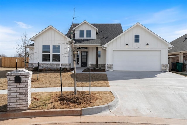 view of front of property featuring roof with shingles, concrete driveway, board and batten siding, fence, and a garage