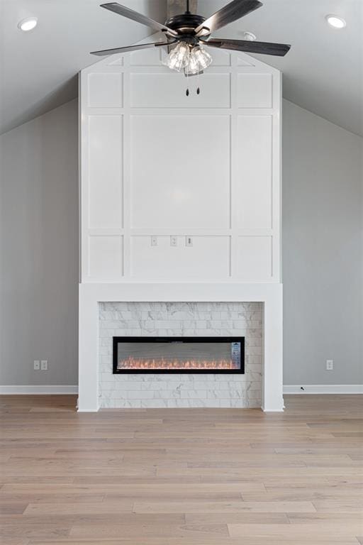 interior space with a fireplace, recessed lighting, a ceiling fan, wood finished floors, and baseboards