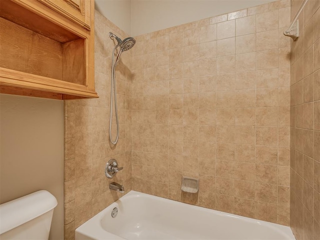 bathroom featuring tiled shower / bath and toilet