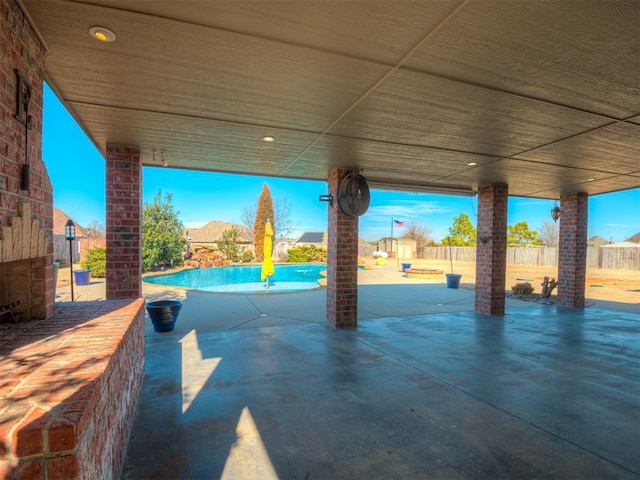 view of patio / terrace featuring fence and an outdoor pool