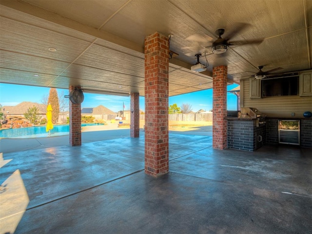 view of patio featuring an outdoor kitchen, a grill, fence, a ceiling fan, and an outdoor pool