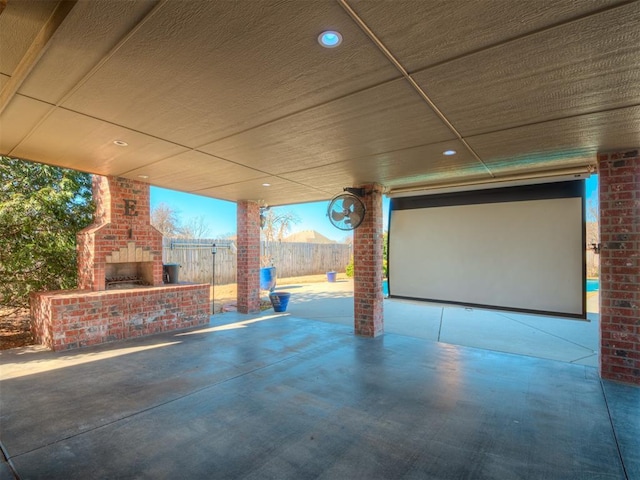 view of patio / terrace with an outdoor brick fireplace and fence