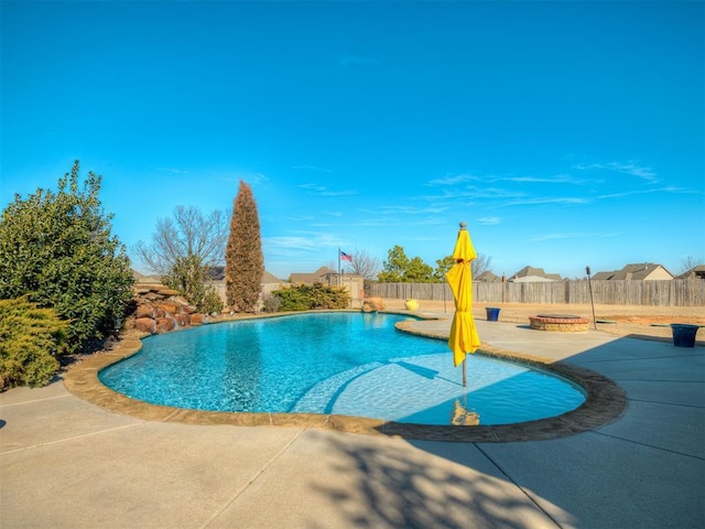 view of pool with an outdoor fire pit and a patio area