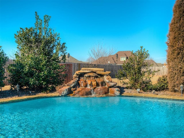 view of swimming pool with fence