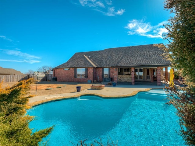 view of pool with a patio, fence, a fenced in pool, and a hot tub