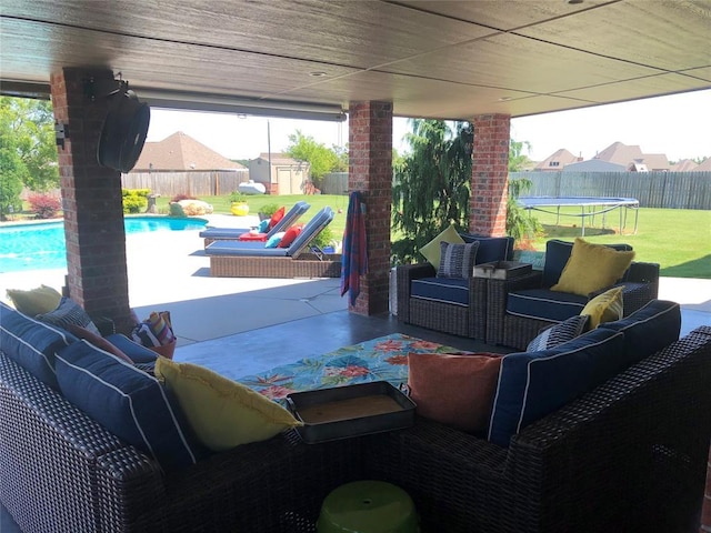 view of patio featuring a shed, a trampoline, a fenced backyard, and an outdoor living space