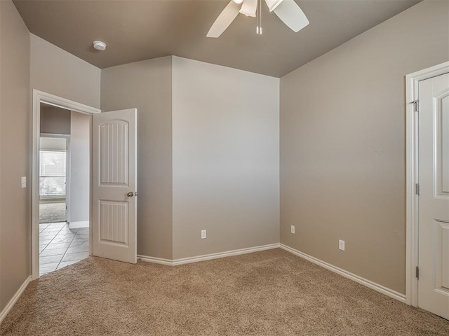 unfurnished room featuring light colored carpet and ceiling fan