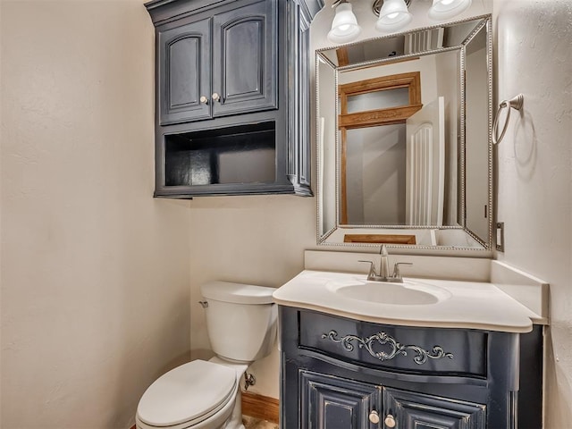 half bathroom featuring toilet and vanity