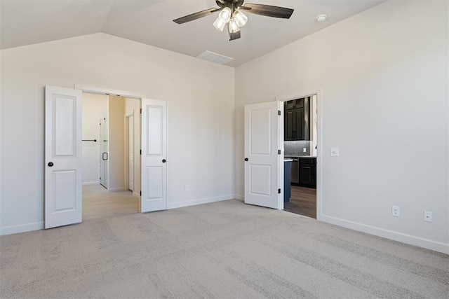 13325 SW 8th St, Yukon, OK 73099 - unfurnished bedroom with baseboards, light carpet, and lofted ceiling