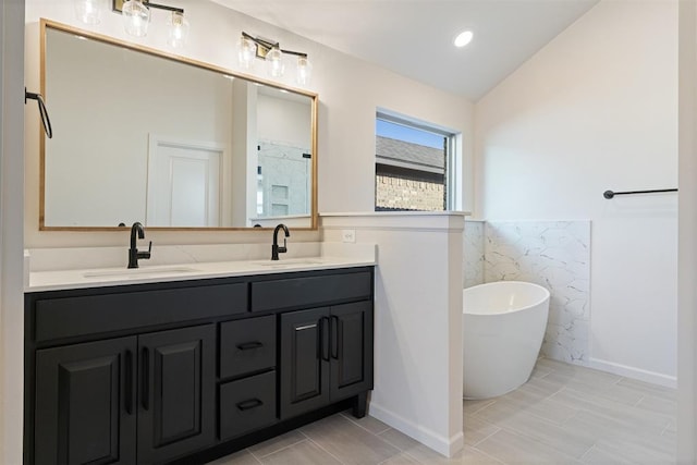 13325 SW 8th St, Yukon, OK 73099 - bathroom featuring a sink, a freestanding tub, double vanity, and lofted ceiling