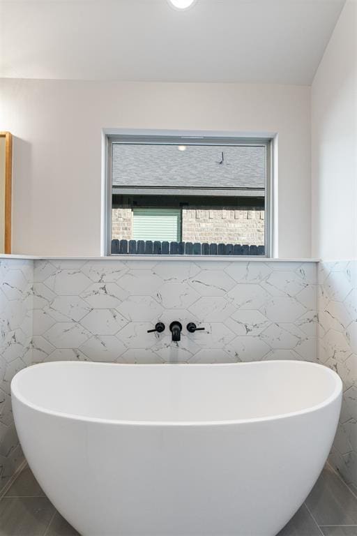 13325 SW 8th St, Yukon, OK 73099 - bathroom featuring a freestanding tub, tile walls, and wainscoting