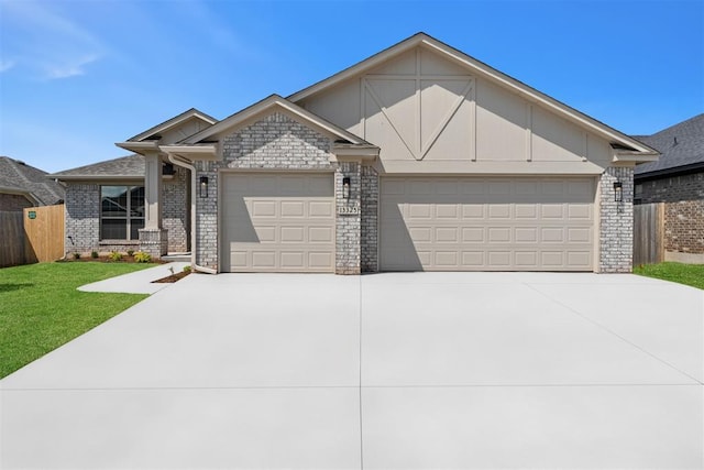 13325 SW 8th St, Yukon, OK 73099 - view of front of house featuring a garage, brick siding, fence, a front lawn, and concrete driveway