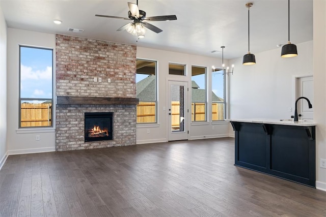 13325 SW 8th St, Yukon, OK 73099 - unfurnished living room featuring a sink, plenty of natural light, a ceiling fan, and visible vents
