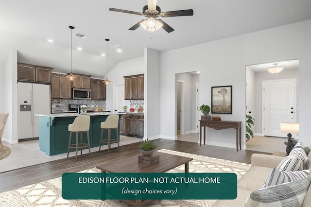 living room with vaulted ceiling, ceiling fan, and light hardwood / wood-style floors