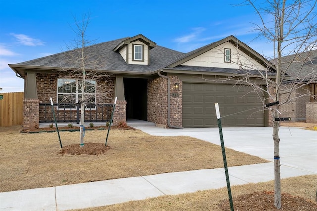 view of front facade featuring a garage, brick siding, concrete driveway, and a shingled roof