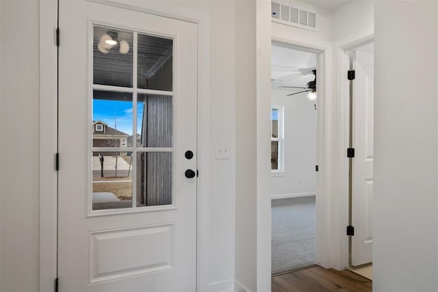 entryway with visible vents, baseboards, ceiling fan, and wood finished floors