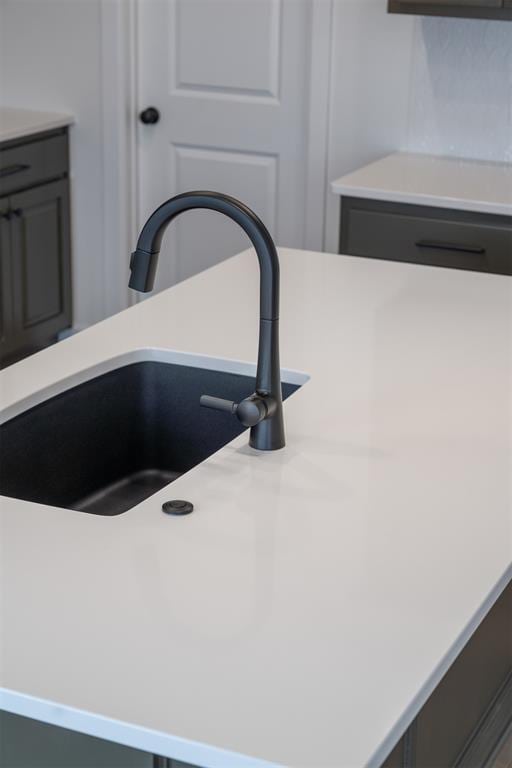 room details featuring light countertops and a sink