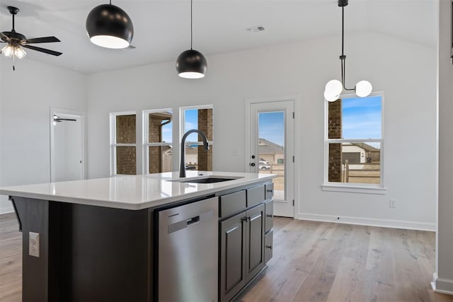 kitchen with visible vents, light countertops, stainless steel dishwasher, light wood-style floors, and a sink