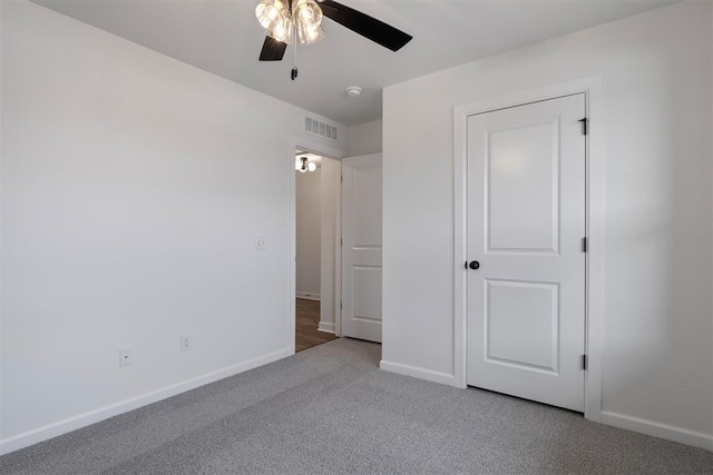 unfurnished bedroom with visible vents, carpet flooring, a ceiling fan, and baseboards