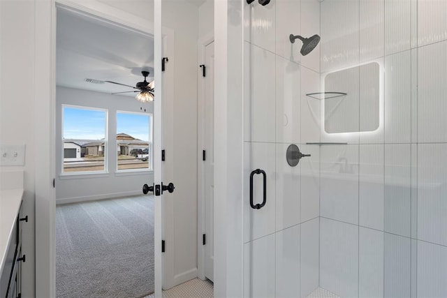 bathroom featuring visible vents, baseboards, ceiling fan, and a shower stall