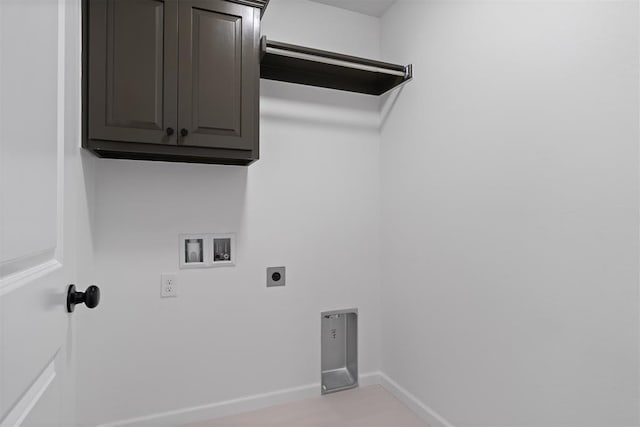 laundry area with cabinet space, hookup for a washing machine, hookup for an electric dryer, and baseboards