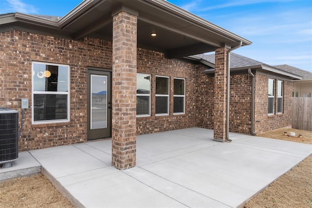 view of patio featuring central AC and fence