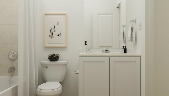 full bathroom featuring tiled shower / bath combo, vanity, and toilet