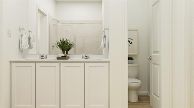 bathroom with vanity, hardwood / wood-style flooring, a shower, and toilet