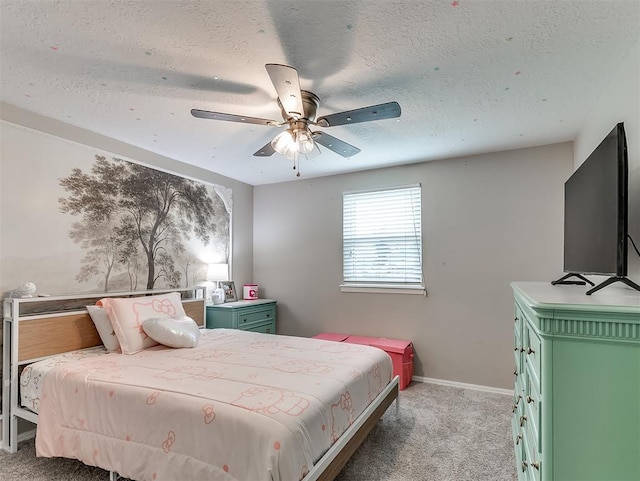 carpeted bedroom with ceiling fan and a textured ceiling