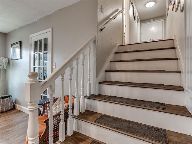 stairway with hardwood / wood-style floors