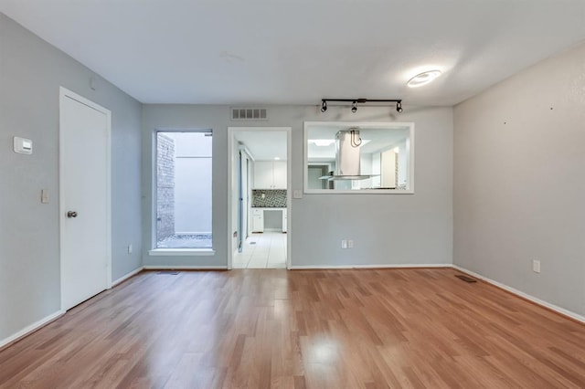 spare room with light hardwood / wood-style floors