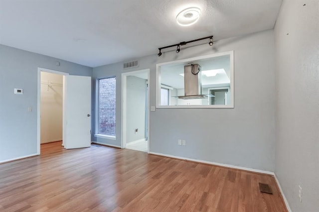 unfurnished room with light wood-type flooring