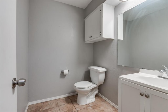 bathroom with tile patterned floors, vanity, and toilet