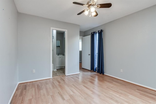 unfurnished bedroom featuring sink, light hardwood / wood-style flooring, and ensuite bathroom